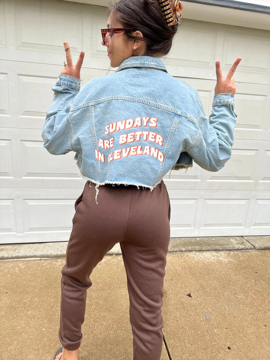 SUNDAYS ARE BETTER IN CLEVELAND CROPPED DENIM JACKET